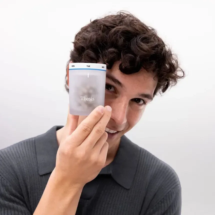 A man holding a Thesis Clarity jar over one eye
