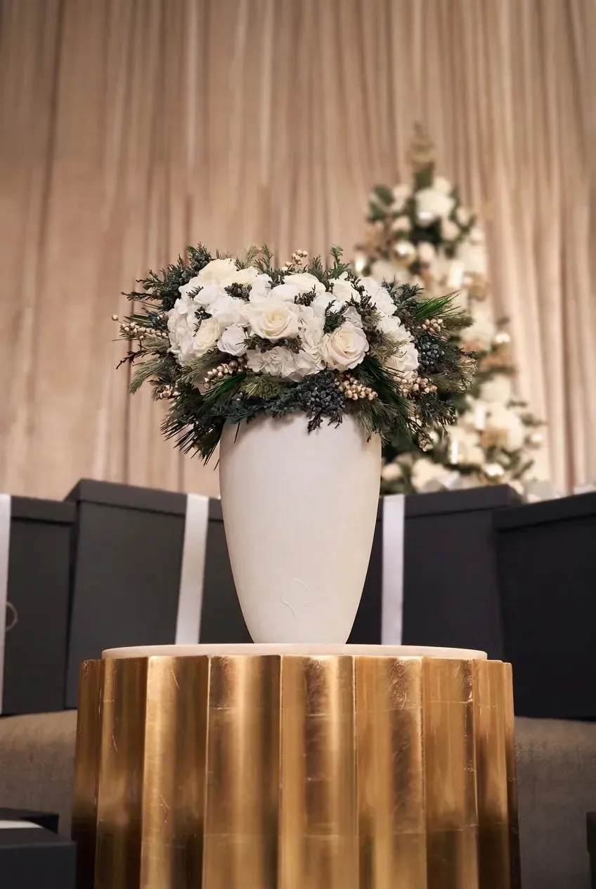 Bois de Rose mixed florals styled on a gold pedestal in a holiday interior